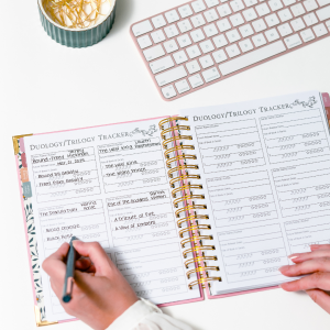 Person writing in planner 